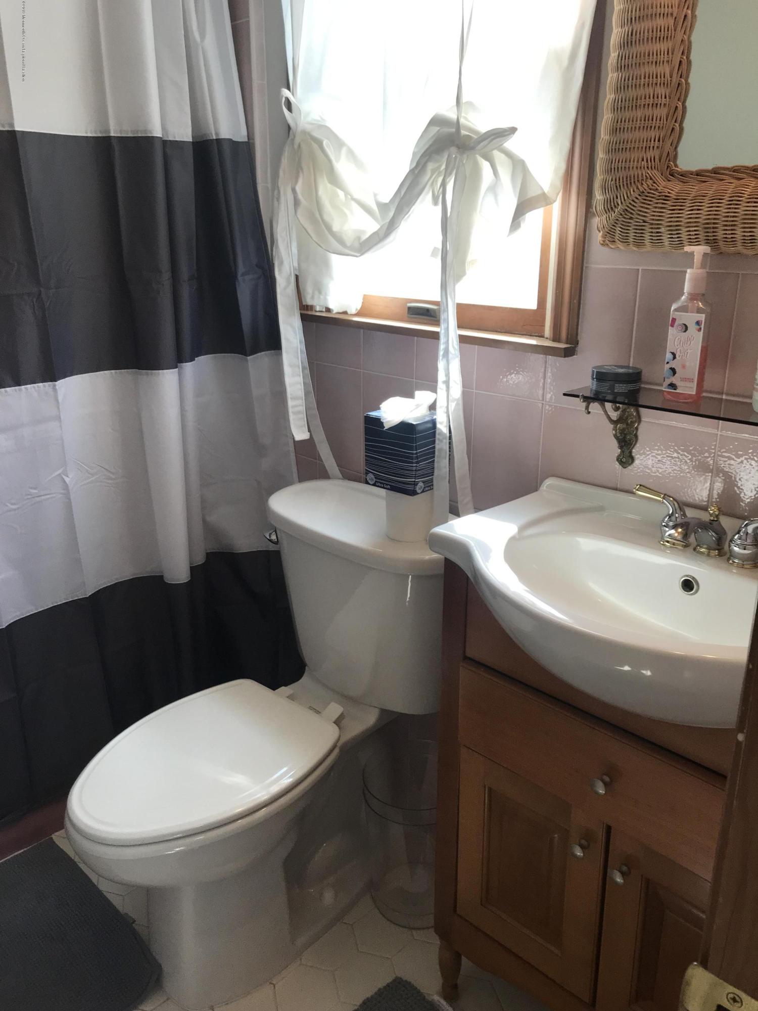 16 Webb Avenue Ocean Grove, NJ 07756 - Photo 25 of 32 a white toilet sitting next to a bathroom sink