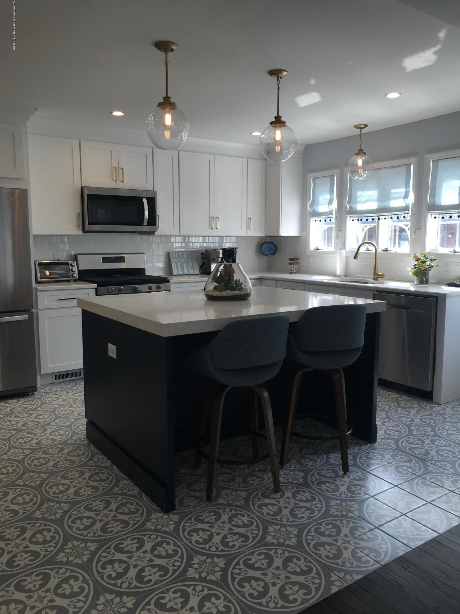 16 Webb Avenue Ocean Grove, NJ 07756 - Photo 6 of 32 a kitchen with stainless steel appliances granite countertop a sink a stove a microwave and a refrigerator