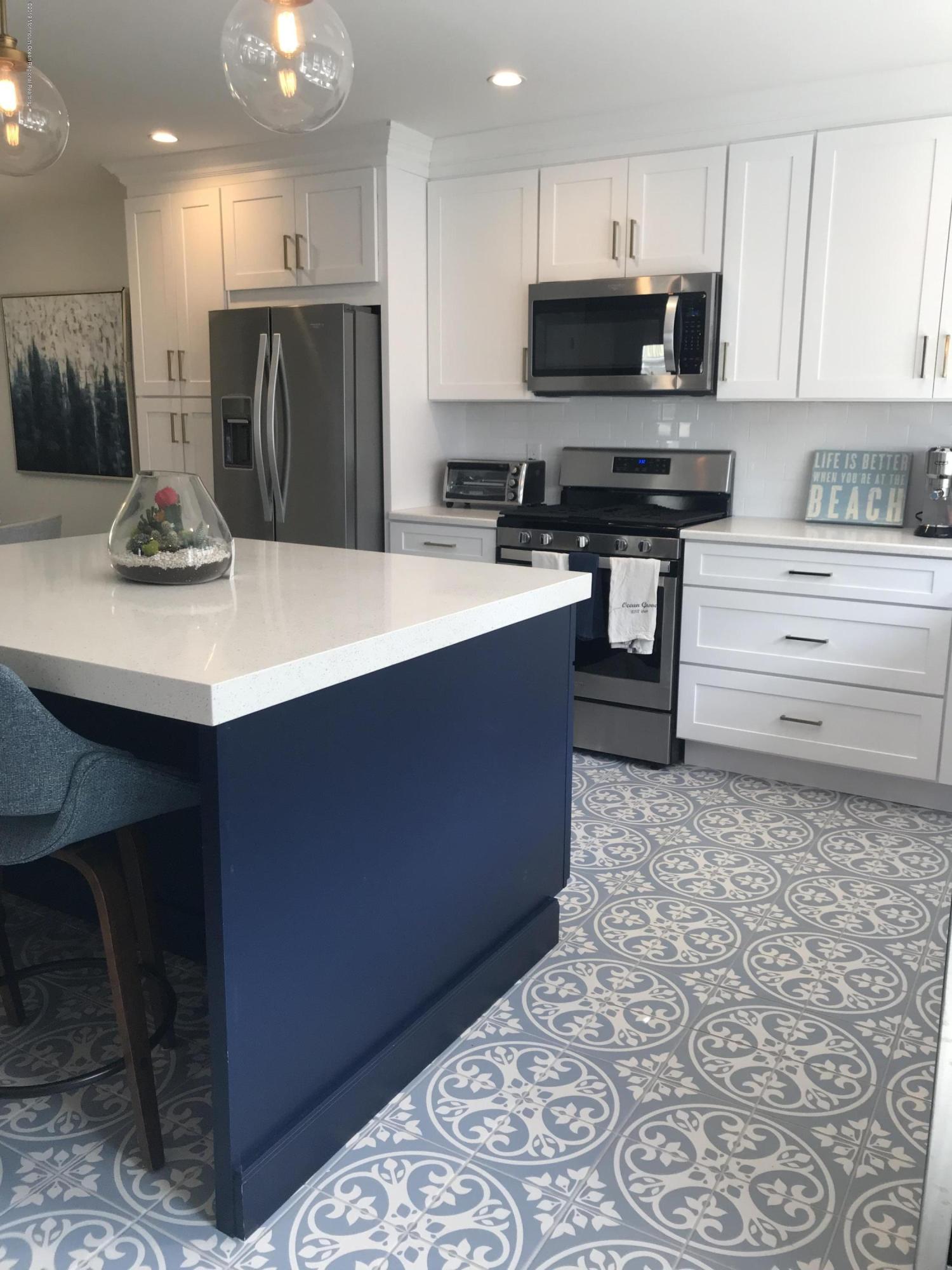 16 Webb Avenue Ocean Grove, NJ 07756 - Photo 7 of 32 a kitchen with stainless steel appliances kitchen island granite countertop a sink and cabinets