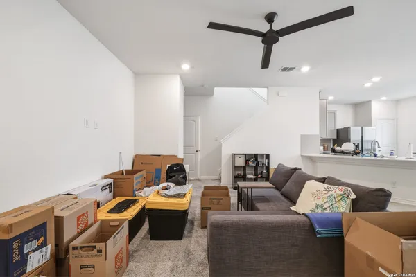 a living room with furniture and kitchen view