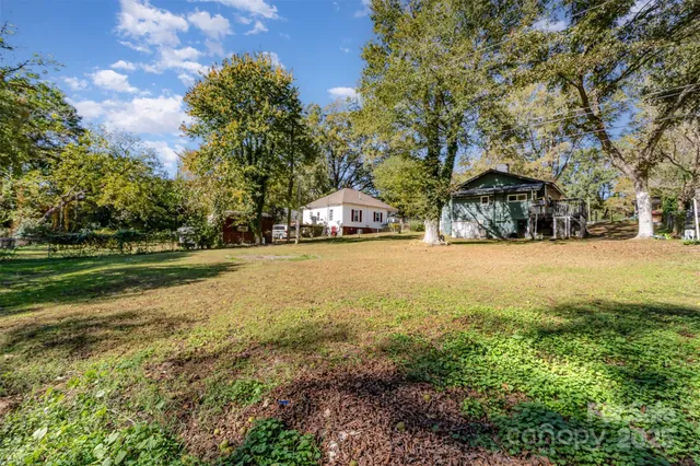 a yellow house with trees in front of it