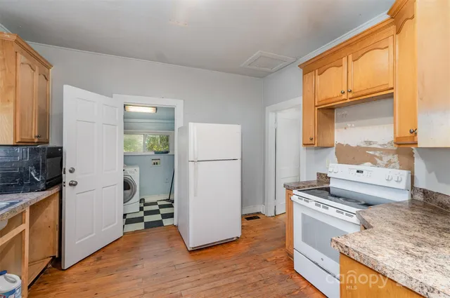 a kitchen with a refrigerator sink and stove