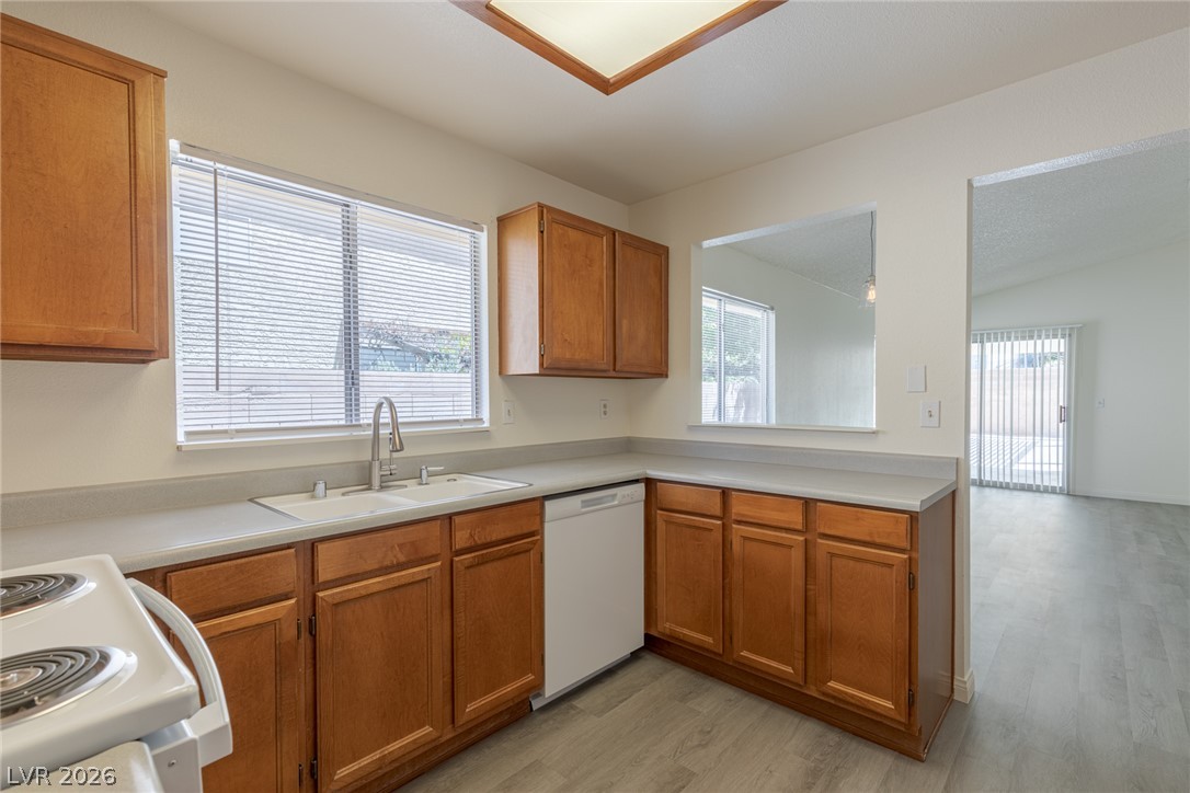 2803 Mirage Road Henderson, NV 89074 - Photo 16 of 39 Ample wood cabinetry and resilient laminate flooring frame this functional kitchen workspace.