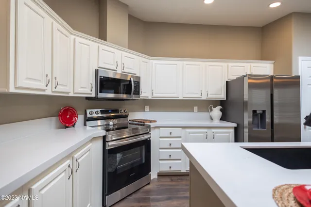 a bedroom with a bed and a lamp on dresser