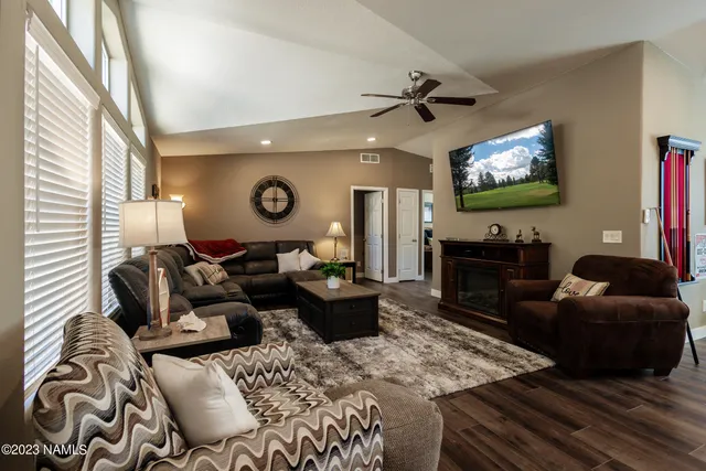 a living room with furniture and a lamp