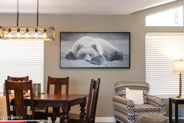 a bedroom with a bed and a lamp on dresser