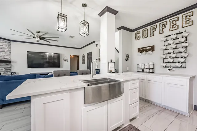 a kitchen with a sink and a stove top oven