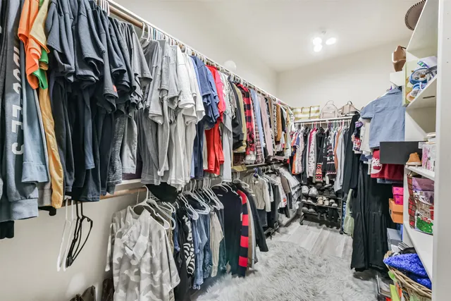 a spacious bathroom with a shower sink and mirror