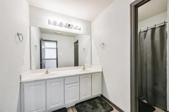 a bedroom with bed and a flat screen tv