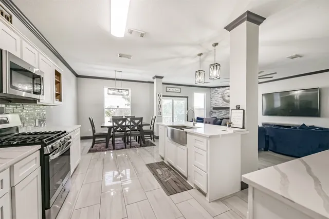 a kitchen with stainless steel appliances kitchen island granite countertop a sink and cabinets