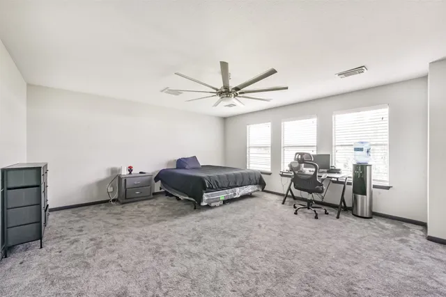 an aerial view of residential houses with outdoor space and parking