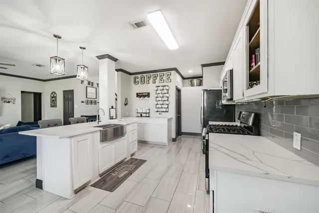 a kitchen with white cabinets and white appliances