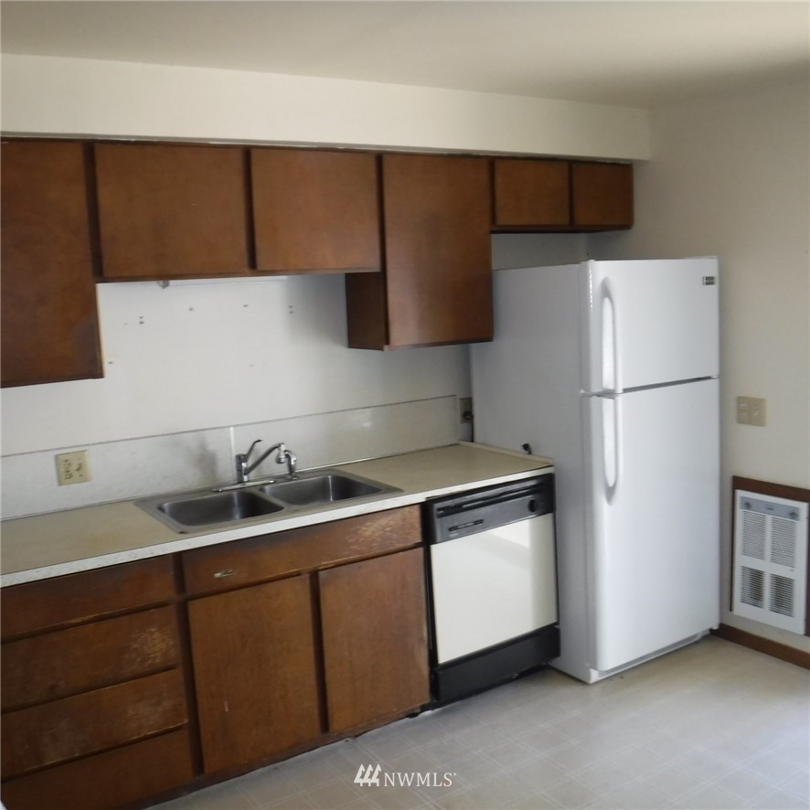 18107 Corvallis Street Southwest Rochester, WA 98579 - Photo 11 of 17 a kitchen with a sink and a refrigerator