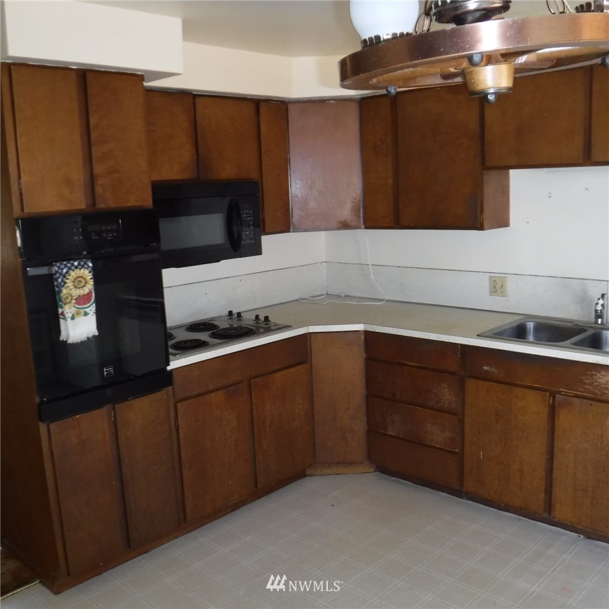18107 Corvallis Street Southwest Rochester, WA 98579 - Photo 12 of 17 a kitchen with wooden cabinets and a sink