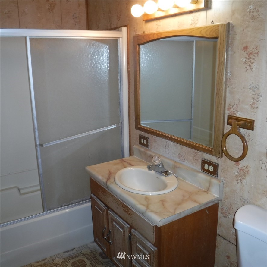 18107 Corvallis Street Southwest Rochester, WA 98579 - Photo 13 of 17 a bathroom with a sink and mirror with toilet