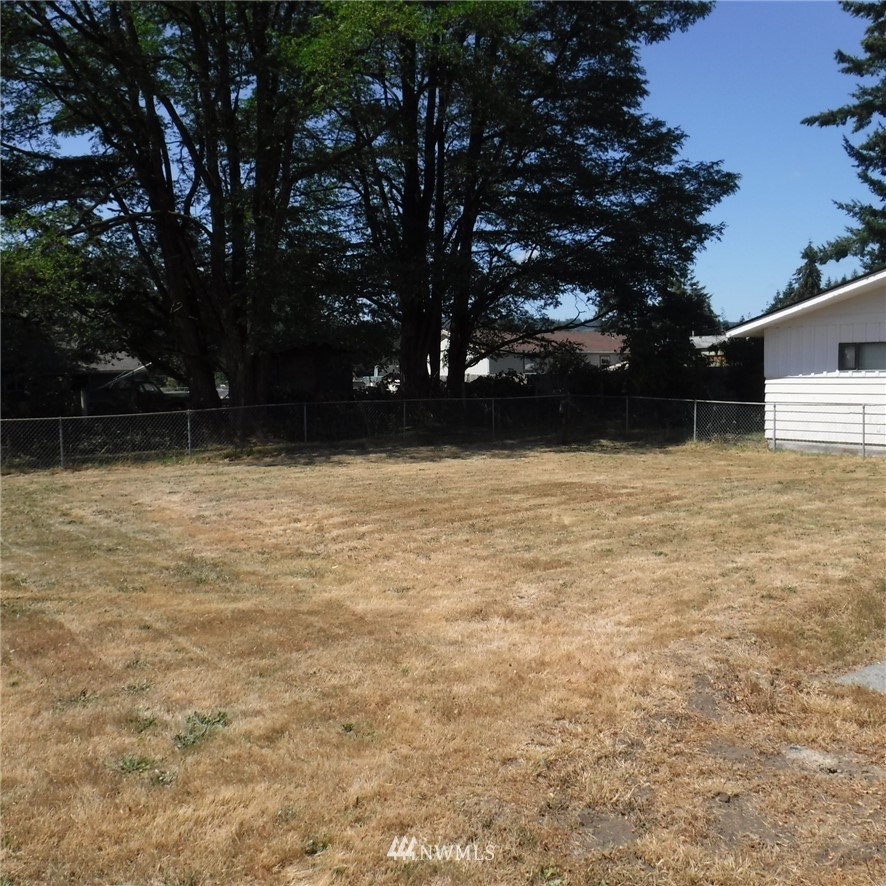 18107 Corvallis Street Southwest Rochester, WA 98579 - Photo 7 of 17 a view of backyard with wooden fence and large trees