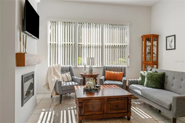 a living room with furniture fireplace and flat screen tv