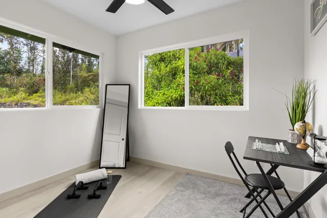 a view of a workspace with furniture and a window
