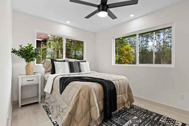 a bed sitting in a bedroom next to a window