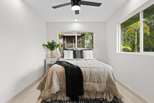 a bed sitting in a bedroom next to a window