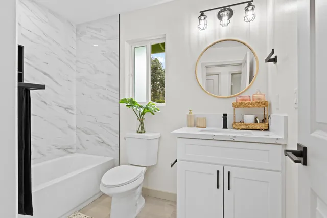 a bathroom with a sink toilet and a mirror