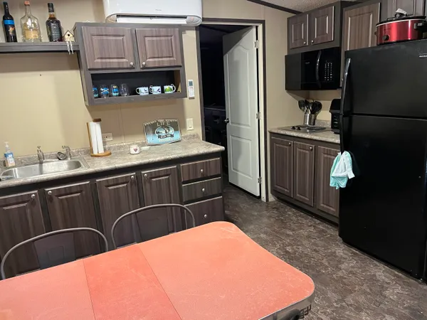 a kitchen with a sink appliances and cabinets