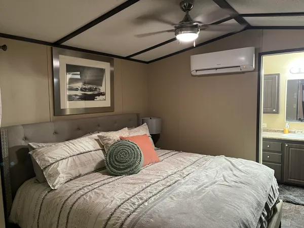 a bedroom with a bed and a chandelier