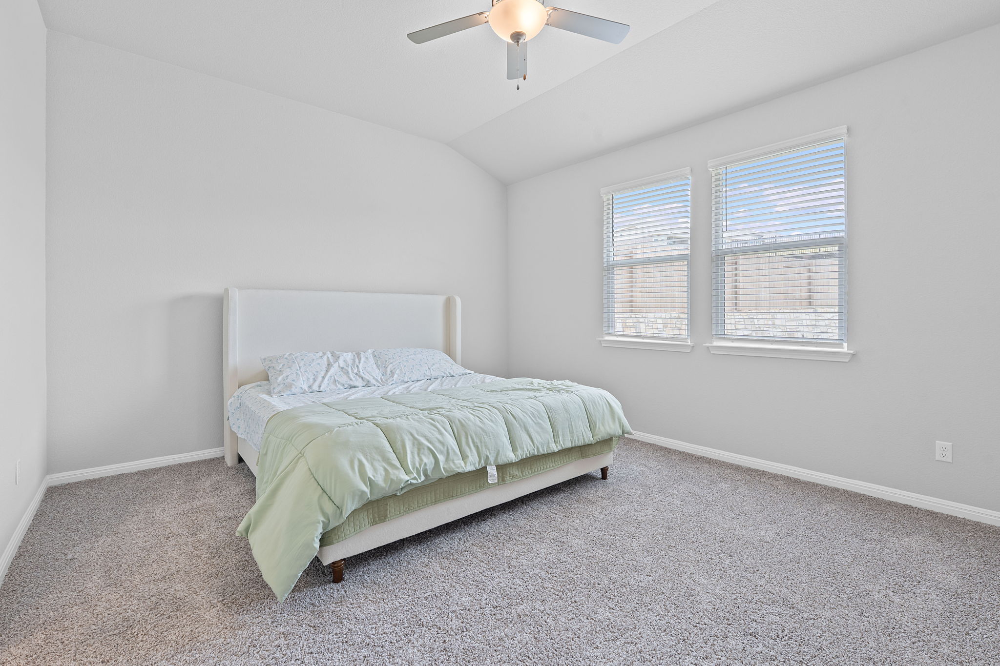 571 Sue Peaks Loop Dripping Springs, TX 78620 - Photo 13 of 29 a spacious bedroom with a bed and a chandelier fan