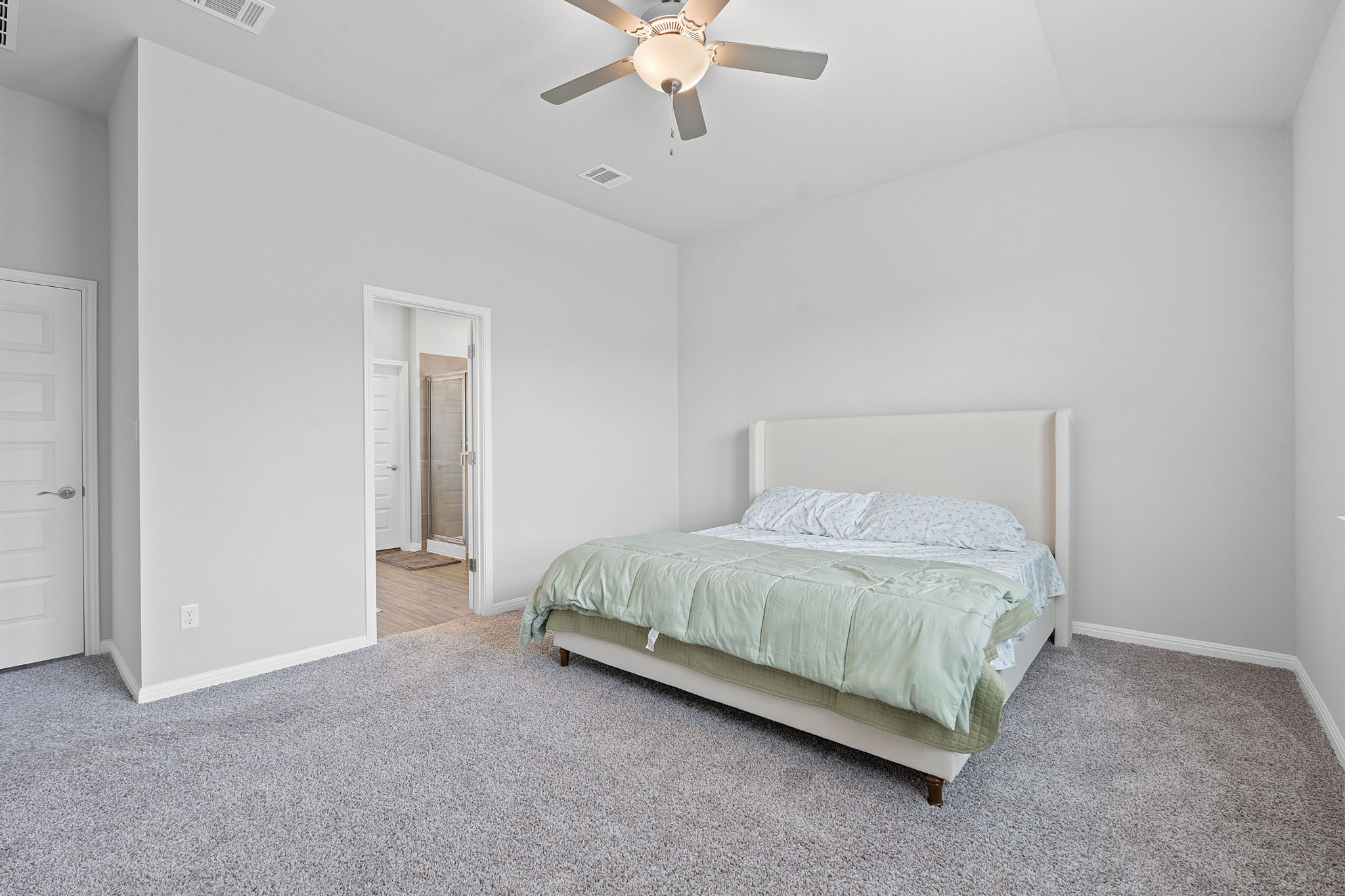 571 Sue Peaks Loop Dripping Springs, TX 78620 - Photo 14 of 29 a spacious bedroom with a bed and a ceiling fan