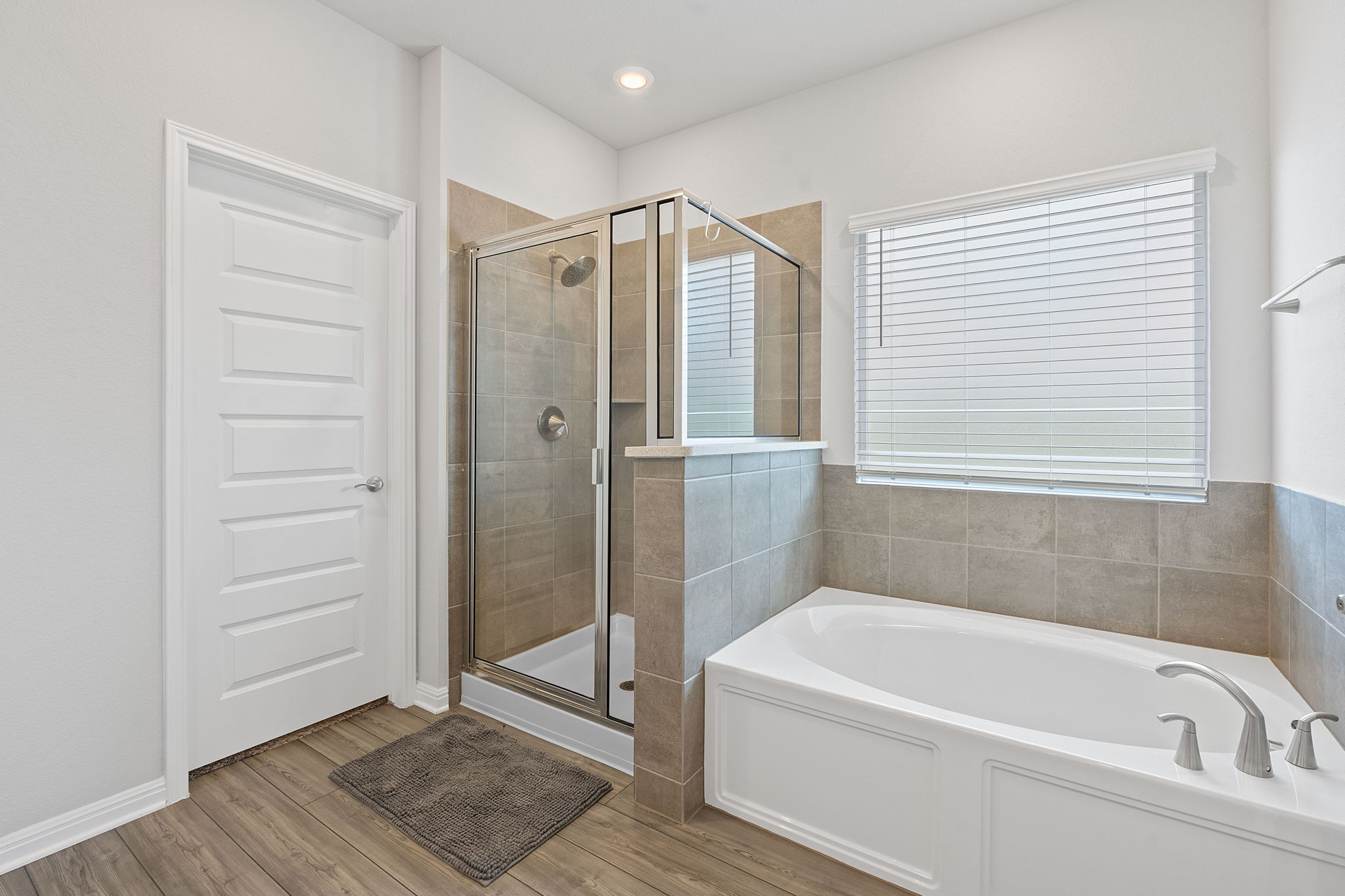 571 Sue Peaks Loop Dripping Springs, TX 78620 - Photo 15 of 29 a bathroom with a bathtub and a shower