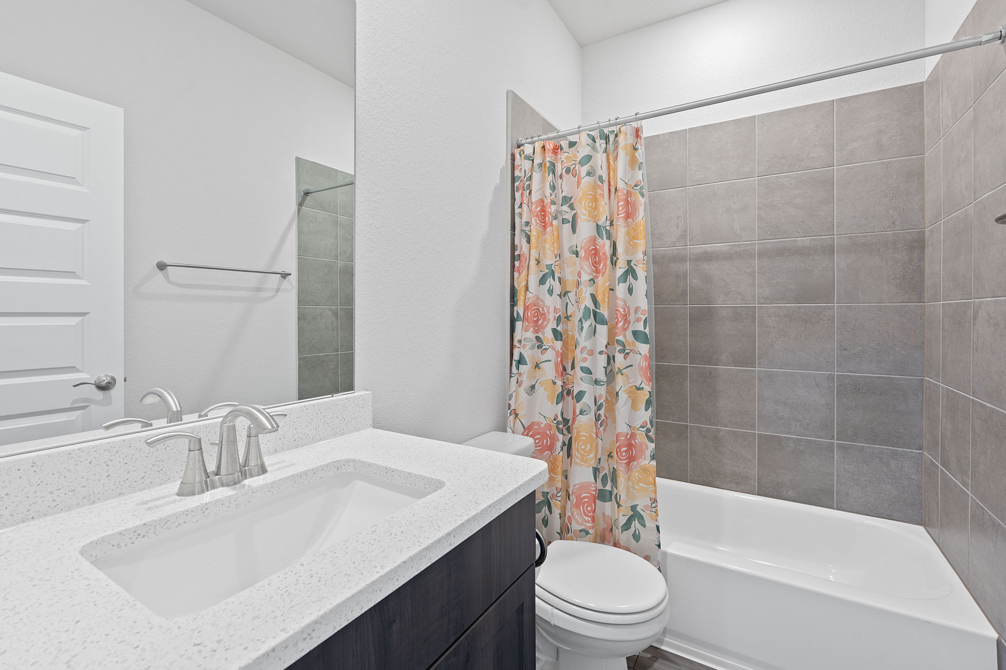 571 Sue Peaks Loop Dripping Springs, TX 78620 - Photo 18 of 29 a bathroom with a sink a toilet and a bathtub