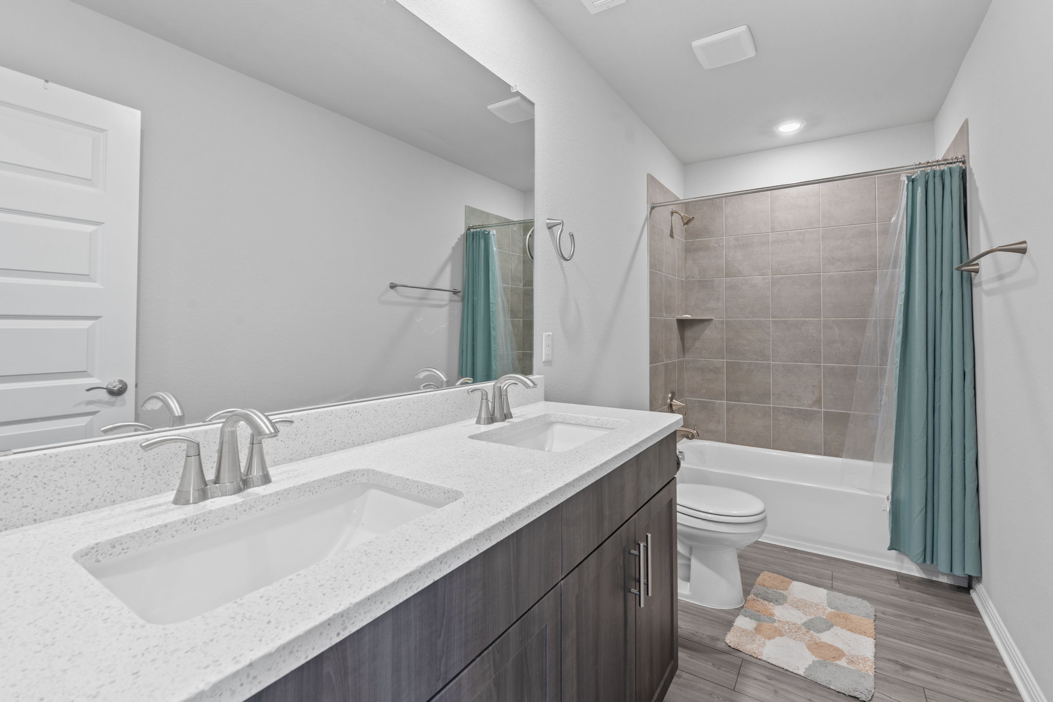 571 Sue Peaks Loop Dripping Springs, TX 78620 - Photo 20 of 29 a bathroom with a sink a toilet a mirror and shower