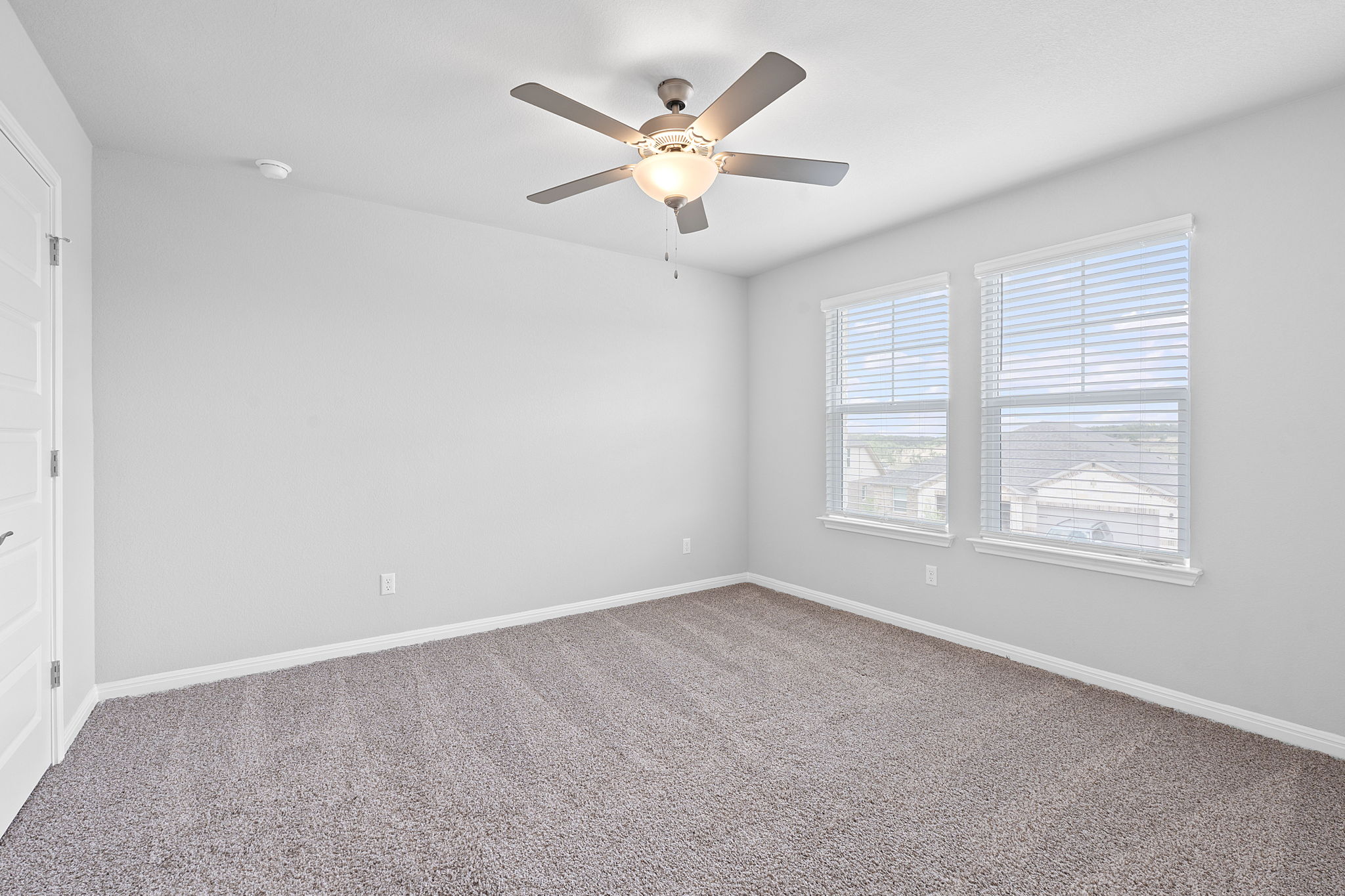 571 Sue Peaks Loop Dripping Springs, TX 78620 - Photo 21 of 29 an empty room with window and ceiling fan