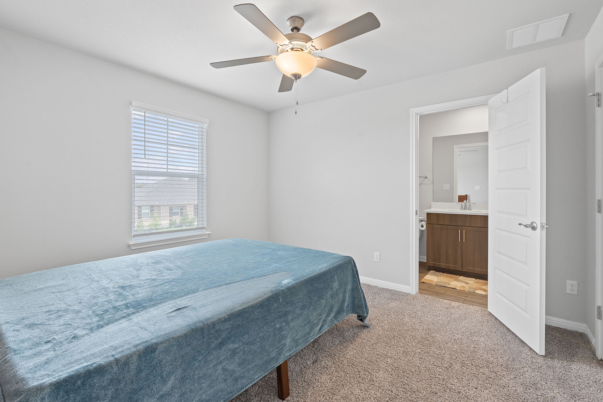 571 Sue Peaks Loop Dripping Springs, TX 78620 - Photo 22 of 29 a bedroom with a bed and a ceiling fan