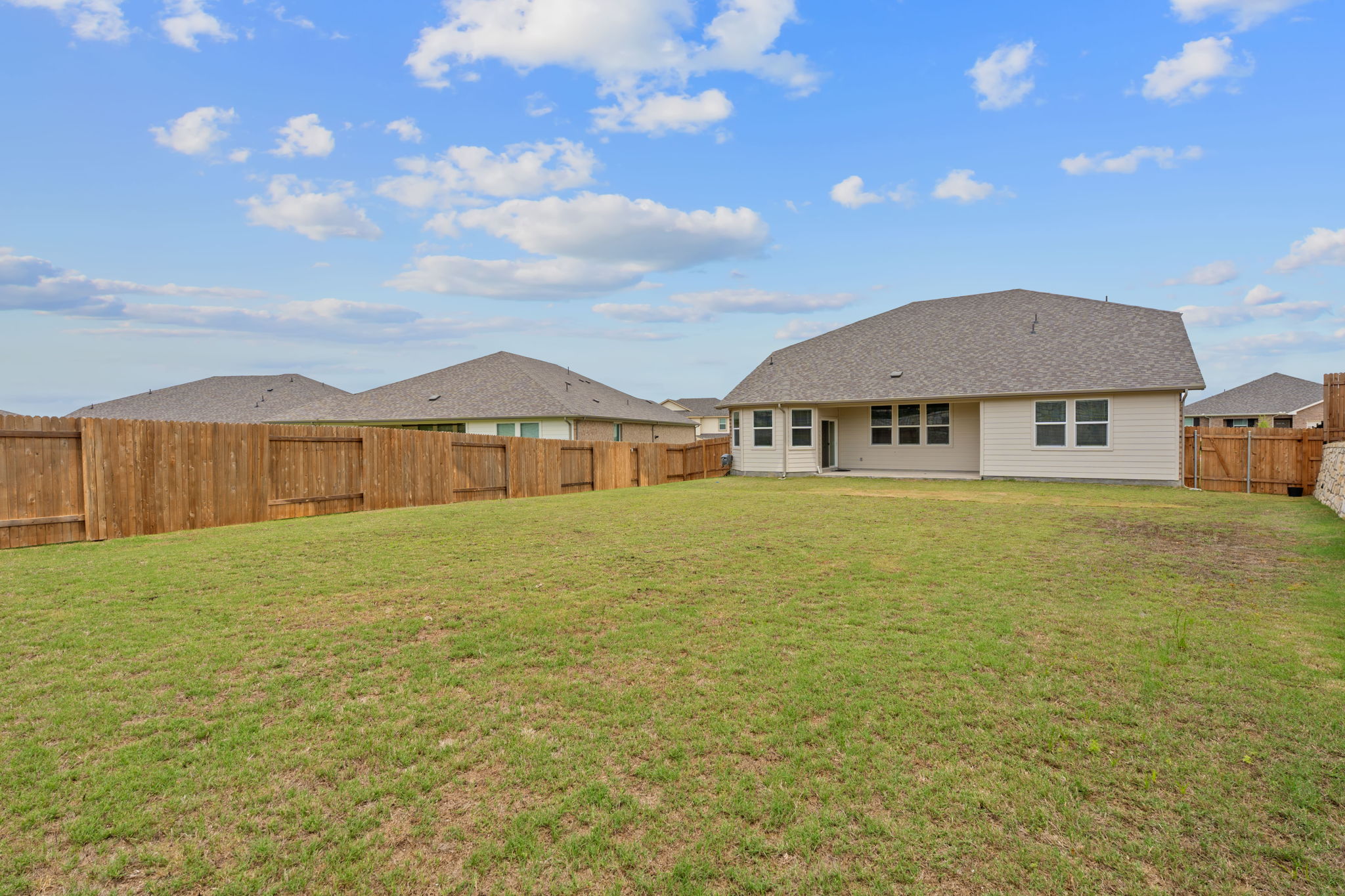571 Sue Peaks Loop Dripping Springs, TX 78620 - Photo 26 of 29 a front view of a house with garden