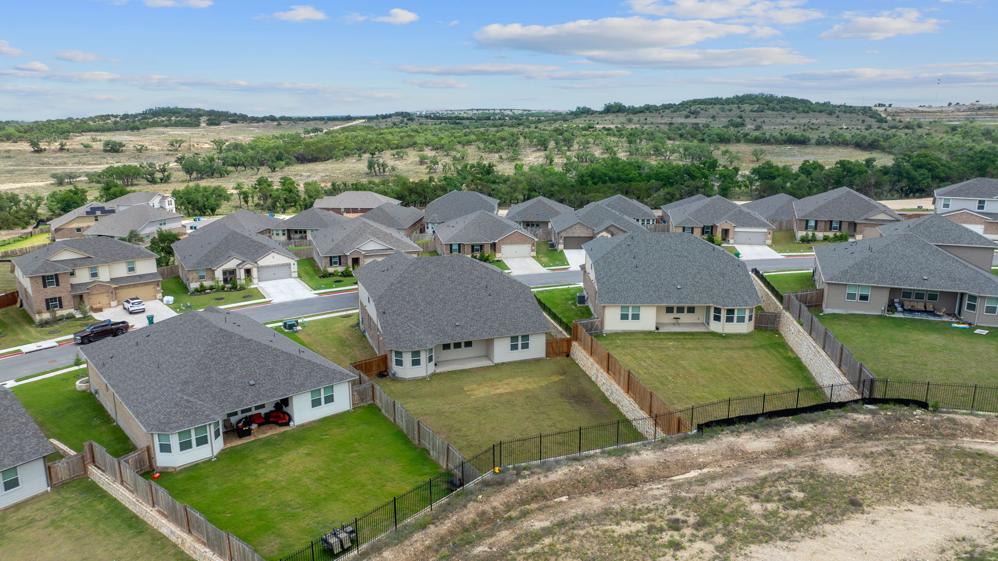 571 Sue Peaks Loop Dripping Springs, TX 78620 - Photo 27 of 29 an aerial view of a house with a garden