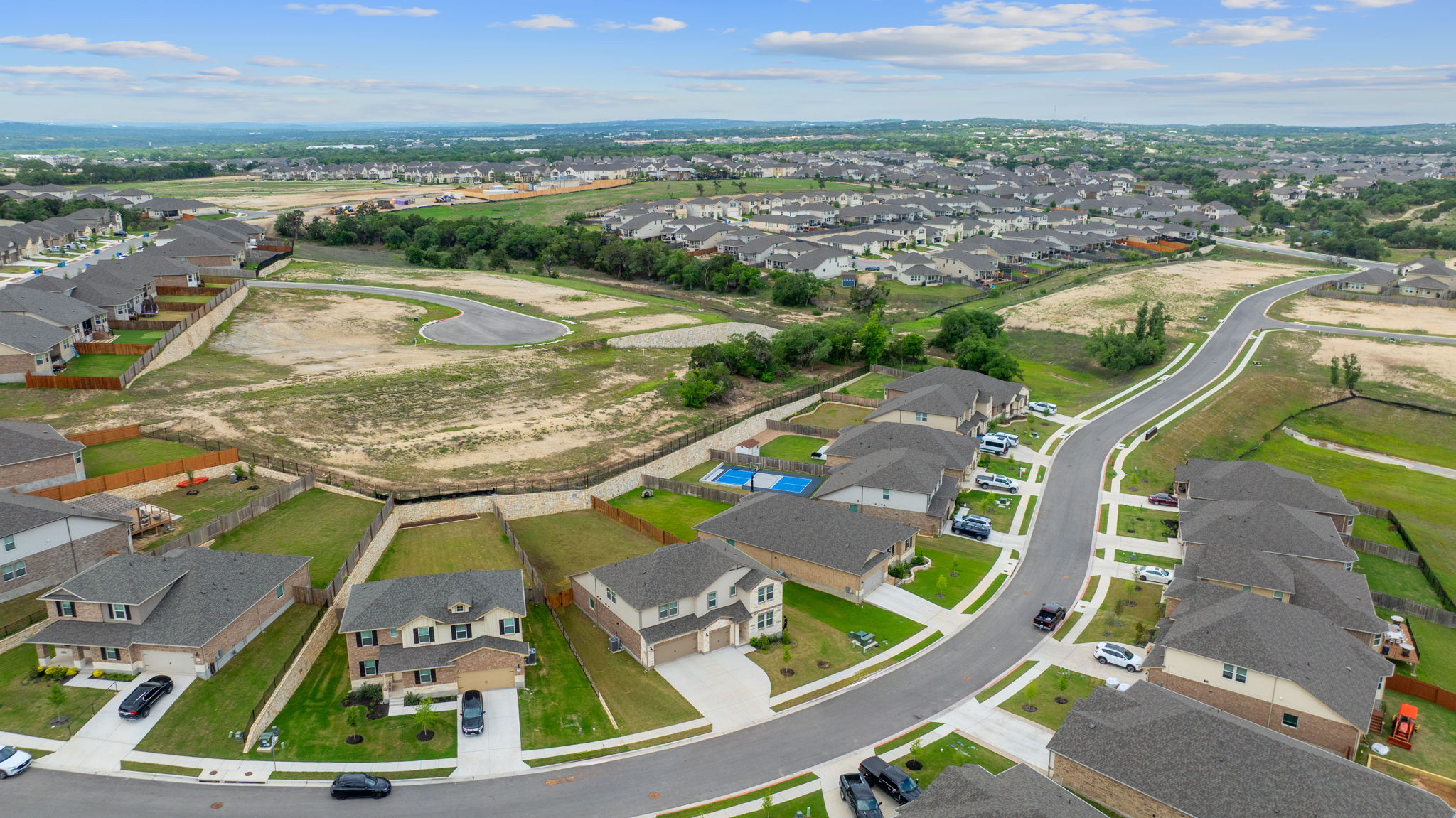 571 Sue Peaks Loop Dripping Springs, TX 78620 - Photo 28 of 29 an aerial view of residential houses with outdoor space