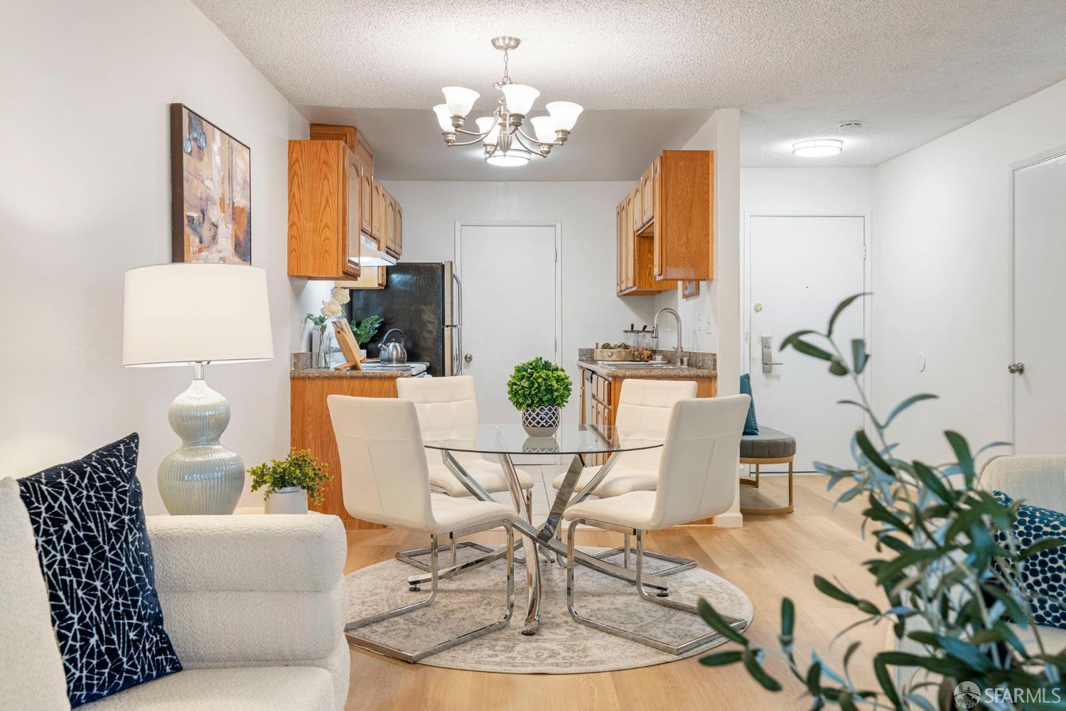 1327 Webster Street, Unit B210 Alameda, CA 94501 - Photo 11 of 54 a living room with patio furniture and a chandelier