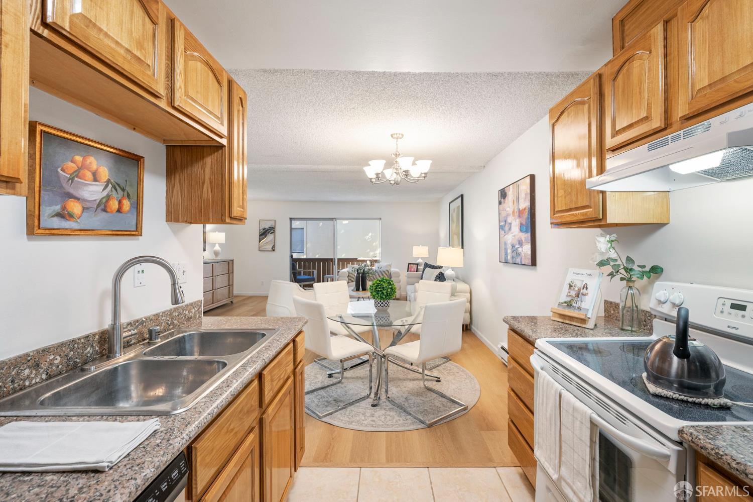 1327 Webster Street, Unit B210 Alameda, CA 94501 - Photo 12 of 54 a kitchen with a sink cabinets a counter top space and stainless steel appliances