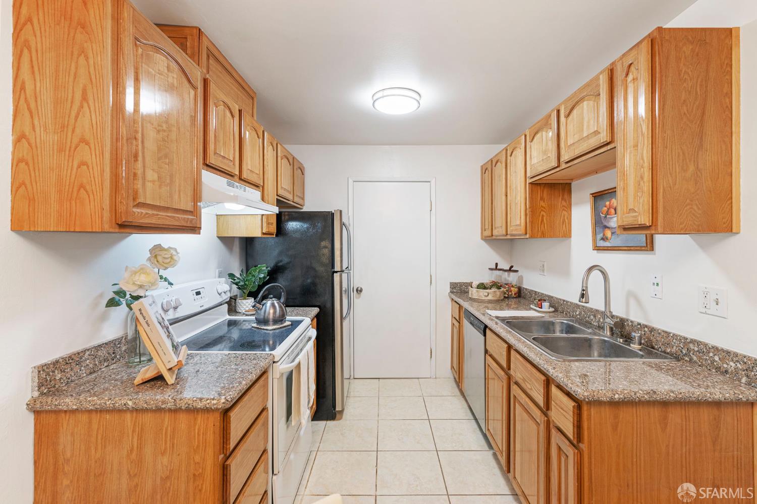 1327 Webster Street, Unit B210 Alameda, CA 94501 - Photo 13 of 54 a kitchen with stainless steel appliances granite countertop a sink stove and refrigerator