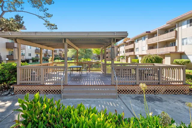 a view of a chairs and table in grill with wooden floor