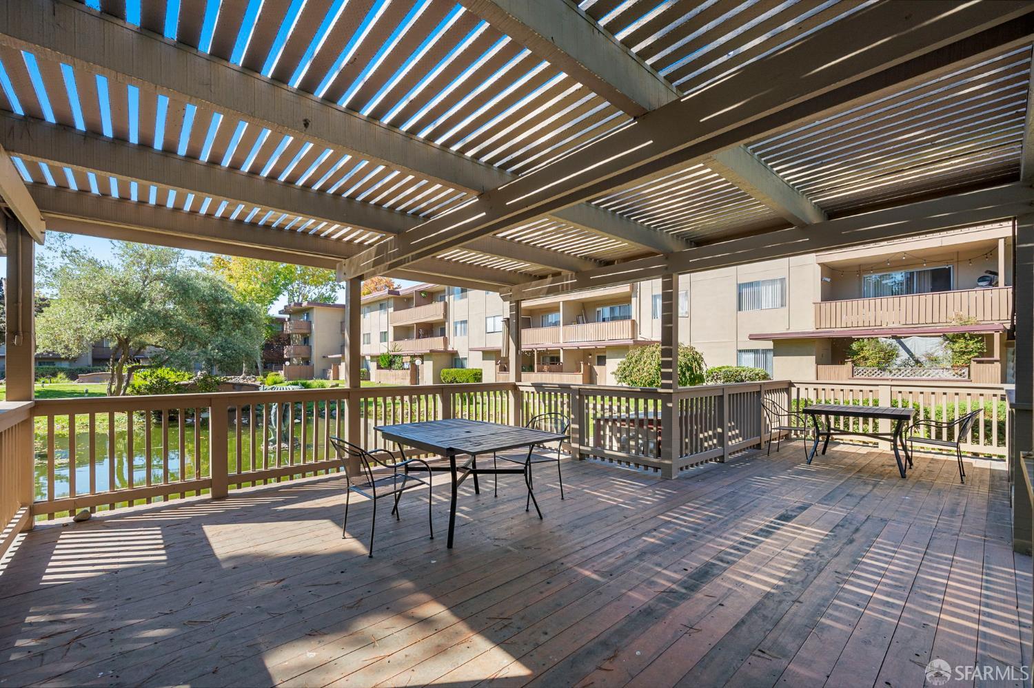 1327 Webster Street, Unit B210 Alameda, CA 94501 - Photo 29 of 54 a view of a chairs and table in grill with wooden floor