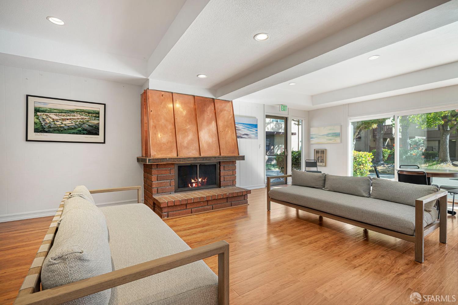 1327 Webster Street, Unit B210 Alameda, CA 94501 - Photo 39 of 54 a living room with furniture large window and a fireplace