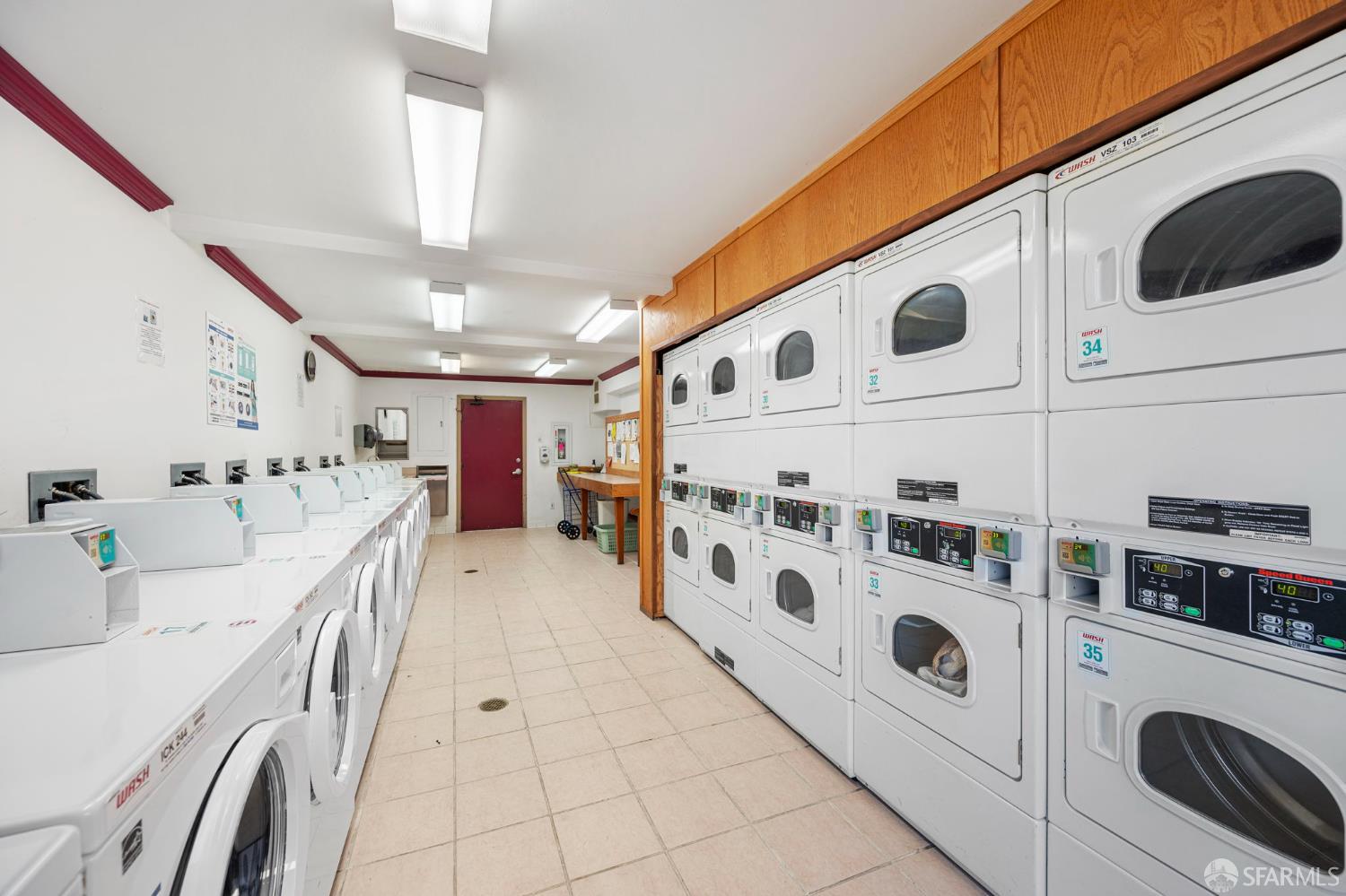 1327 Webster Street, Unit B210 Alameda, CA 94501 - Photo 42 of 54 a large white kitchen with stainless steel appliances granite countertop lots of white cabinets a sink a stove and a refrigerator