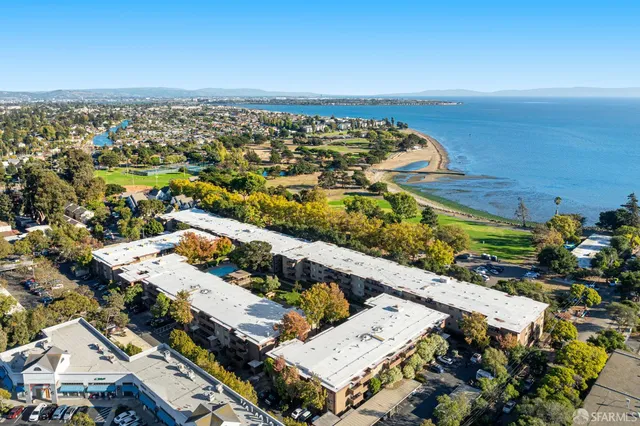 an aerial view of residential houses with city view