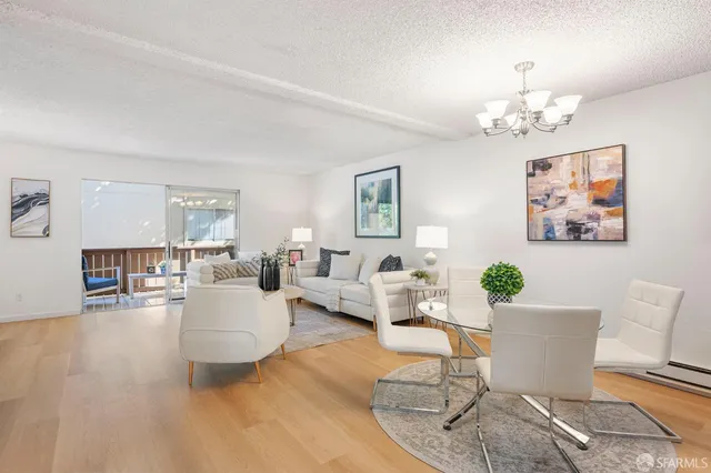 a living room with furniture dining table and a wooden floor