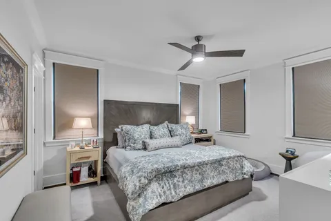a bedroom with a large bed and a chandelier