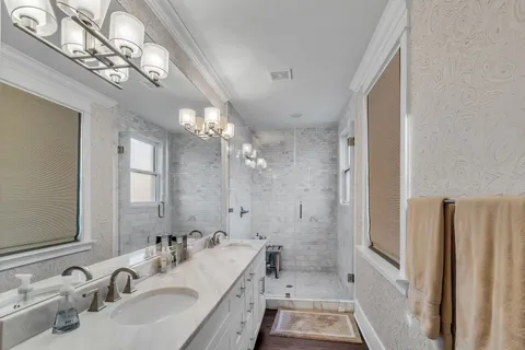 a bathroom with a tub sink and mirror