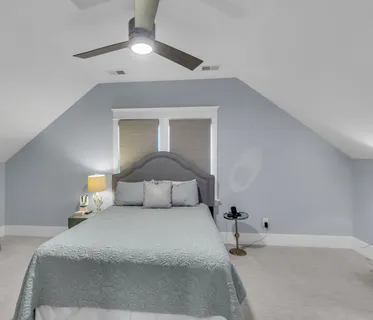 a bedroom with a bed and a lamp
