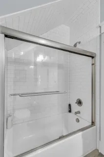 a bathroom with a shower and a bath tub